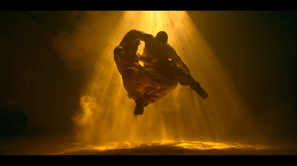 A hyper-dynamic 16:9 movie trailer scene. An explosive breakdancing crew of five powerful dancers captured mid-air performing a synchronized complex…